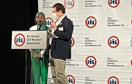 Two people speaking on stage at the 21st Annual HS Research Conference.
