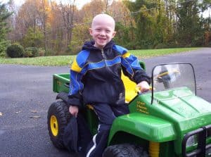 Noah in 2004 riding a tractor