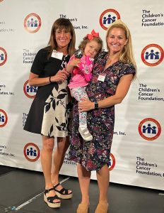 Cameron and Stewi Corno with Tasha at the 6th Annual Research Symposium in June 2022.